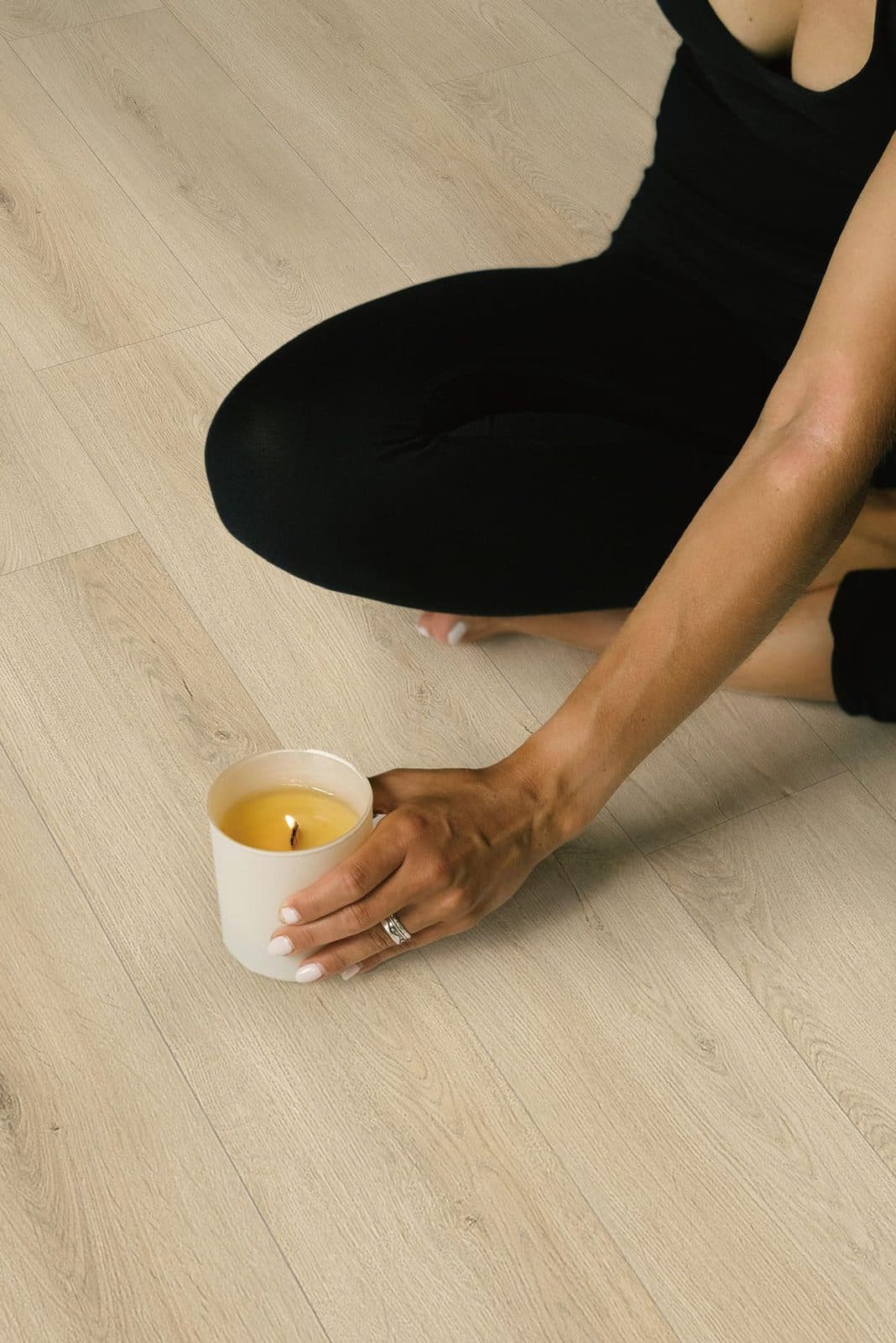 Craftsman installing wide-plank hardwood flooring with precision